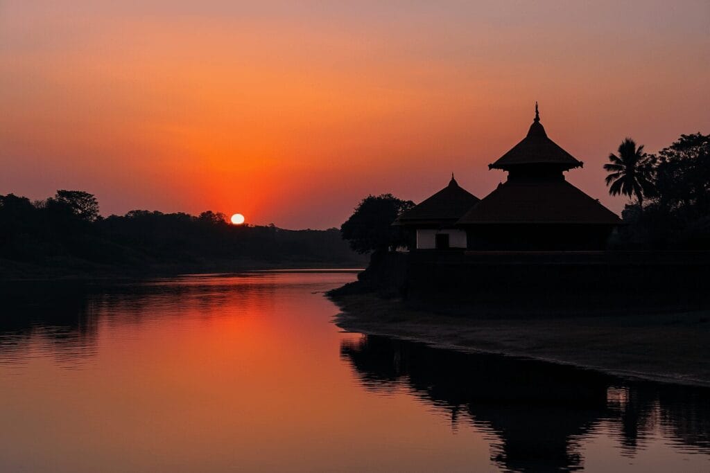 Bharathapuzha River flowing through Chittur with temple and orange sunset